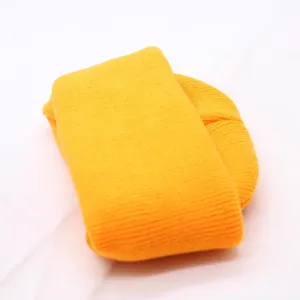 Neon yellow knit beanie detail, soft ribbed texture fabric closeup, casual autumn winter warm cap.