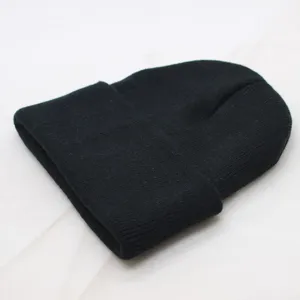 Black cuffed knit beanie detail view, showing the soft woolen texture and classic foldover design.
