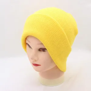 Detail view of vibrant fluorescent yellow knit beanie showing soft ribbed texture closeup.