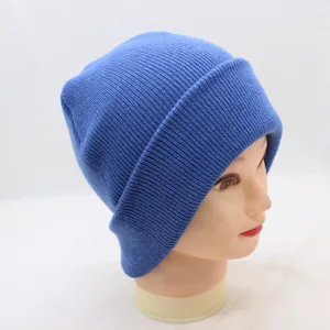 Close-up of a stylish blue knitted beanie hat, highlighting the cozy ribbed fabric and cuffed brim.