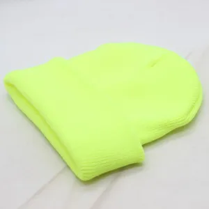 Neon yellow knit beanie detail close-up, solid color winter warm skull cap for daily wear.