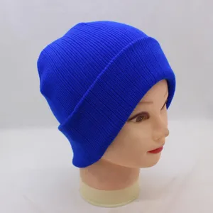 Close-up detail of a vibrant blue ribbed knit beanie hat, showing soft wool texture and foldover.