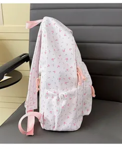 Cute pink floral fabric backpack side detail showing adjustable straps and front pocket design.