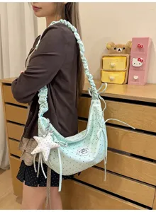 Mint blue polka dot shoulder bag with ruffled strap, bow decor, and star charm for sweet styles