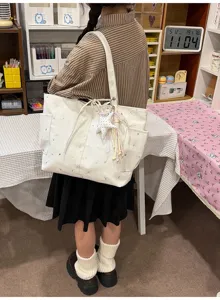 Casual canvas tote bag with star print, stylish shoulder bag for daily commuting and travel.