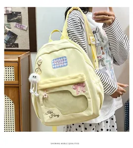 Casual sweet yellow backpack with transparent window, bow embroidery and cute plush pendant.