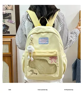 Light yellow cute student backpack with clear window, bow embroidery and lovely plush pendant.