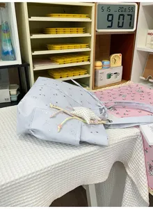 Light blue star moon print shoulder bag underarm tote bag with cute star pendant detail.