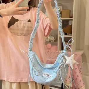 Glacial blue polka dot hobo shoulder bag with bow and star charm for sweet girl daily use.