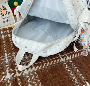 Light grey star pattern backpack interior detail, soft fabric dual shoulder bag close up.