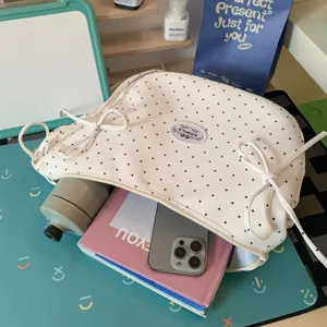 White polka dot crossbody bag with cute bow knots, stylish canvas shoulder bag for daily use.