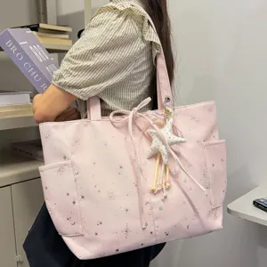 Pink canvas tote bag for women, stylish shoulder handbag with star print, daily commute bag.