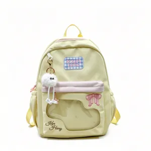 Milky yellow student backpack with clear window, plaid patch, bow embroidery and cute doll charm.
