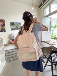 Casual pink and off-white canvas backpack with front clear pocket and cute design.