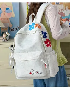 Casual lightweight student schoolbag with colorful floral embroidery and cute speckled canvas design.