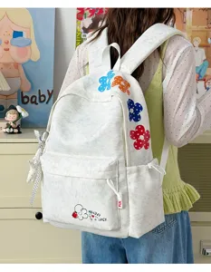 Casual canvas backpack with cute colorful floral embroidery and spacious compartments for daily use.