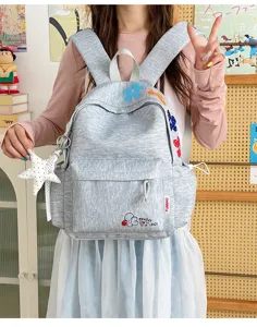 Detailed view of grey heathered casual backpack with lovely embroidered floral pattern.