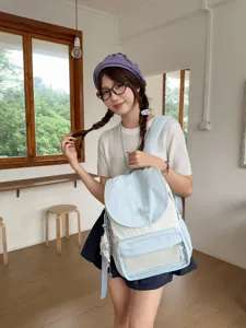 Detailed view of the cute light blue and white canvas backpack for daily casual student use.