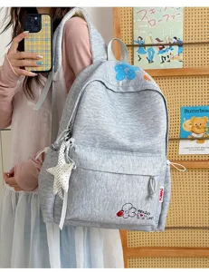 Casual grey student backpack with embroidered floral details, stylish and lightweight daypack.