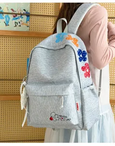Casual lightweight grey student backpack featuring colorful polka dot flower embroidery.