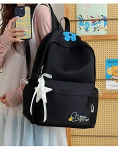 Casual black student backpack with embroidered flower and star pendant for daily school use.
