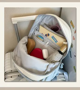 Backpack interior detail showing multiple compartments and spacious storage capacity for daily use.