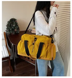 Large capacity yellow travel duffel bag, stylish gym sports shoulder bag detail view.