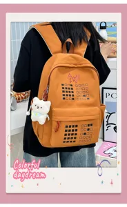 Orange canvas backpack with cute bear pendant and grid pattern, stylish student school bag.