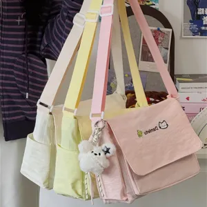 Cute Japanese ins canvas shoulder bag for student daily commute and school use with pendant.