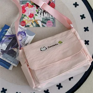 Cute Japanese ins style student shoulder messenger bag with cat embroidery and pink canvas strap.
