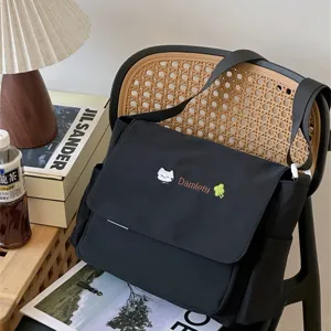 Close-up scene view of the cute Japanese style black canvas messenger bag details.