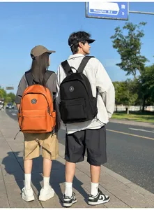 Detail view of minimalist nylon student backpack in outdoor street scene showcasing design