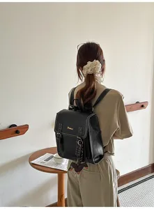 Close-up detail of black leather backpack, stylish design, perfect for daily wear.