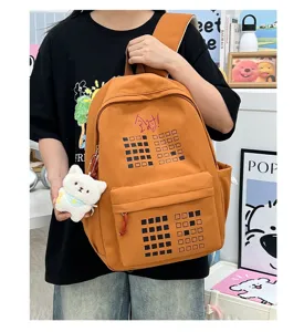 Large capacity student backpack with grid print and cute plush pendant for travel.