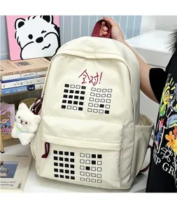 Detail view of canvas backpack with grid pattern, cute pendant and large capacity storage.