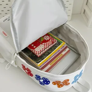White canvas backpack with colorful flower embroidery, large capacity school bag for daily use.