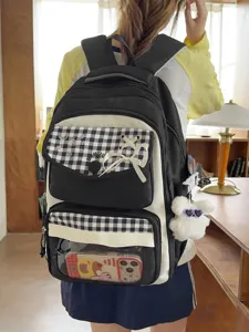 Student black white checkered backpack detail view with transparent pocket and cute bear pendant.