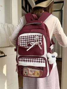 Wine red and white color block plaid student backpack with cute bow and clear front pocket design.
