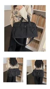 Detailed view of large capacity black travel gym duffel bag with adjustable shoulder strap.