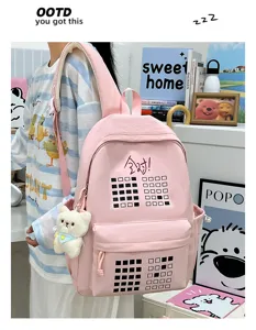 Pink canvas backpack for students, large capacity travel school bag with cute bear pendant.