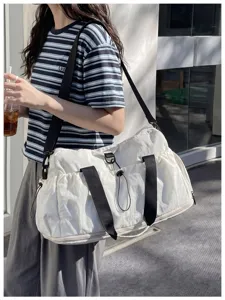 Large capacity travel duffel bag with waterproof nylon material and durable shoulder strap.