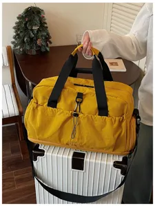 Large capacity travel duffel bag with shoulder strap, waterproof fabric for gym and sports.