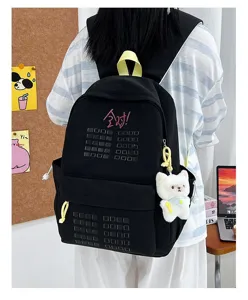 Black student backpack detail featuring cute cat plush pendant and embroidered design.