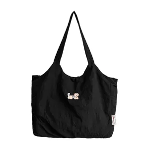 Zwarte canvas tote bag met schattige cartoon hond borduurwerk, minimalistische casual tas.