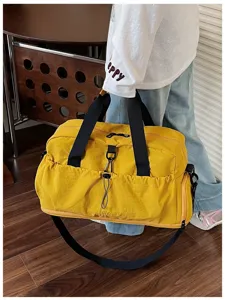 Large capacity yellow travel duffel bag with black straps and multiple pockets for daily use.