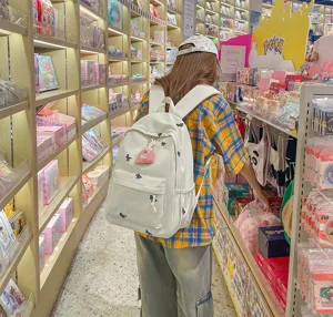 Casual canvas backpack with cute embroidery for students, lightweight daily travel bag.