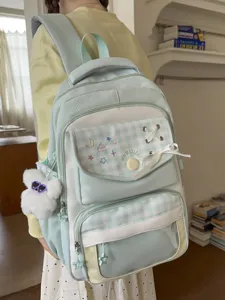 Light blue plaid student backpack with cute embroidery, bow detail and plush pendant.