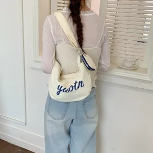 Casual canvas hobo shoulder bag with letter print and small pouch for women daily use.