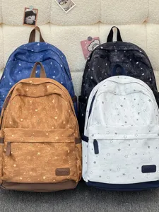 Detailed view of star print canvas backpack, large capacity student school bag in multi.