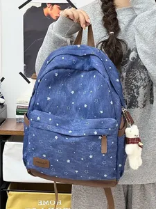 Blue star print canvas backpack with brown leather trim and cute bear pendant for students.